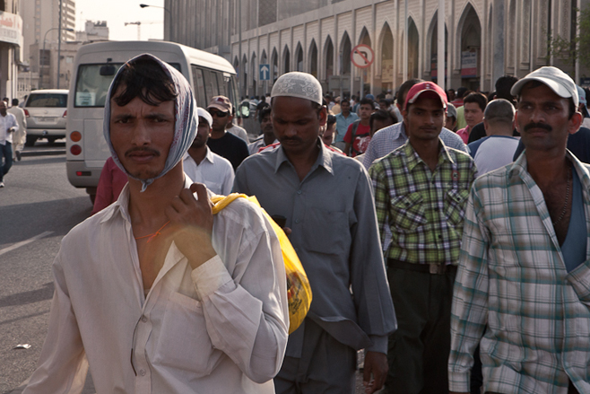 Migrant workers congregate near Bank Street in central Doha on Friday, the weekly day of rest. Some 1.19 million of the 1.26 million people employed in Qatar come from abroad.